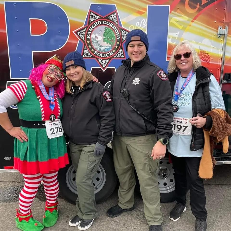 RCPD staff at the run. They are smiling and one is dressed up as a holiday elf